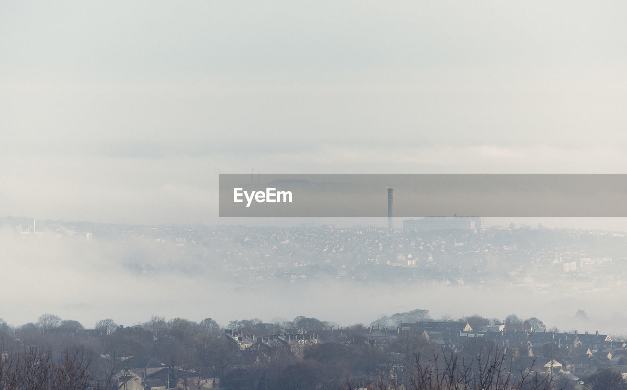 An industrial historical landmark, lister's mill dominates the bradford city horizon in england. 