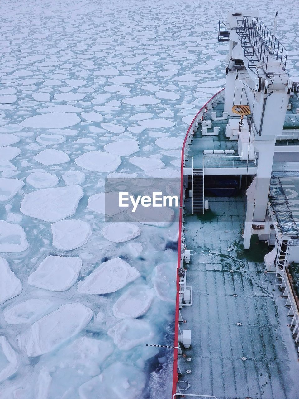 Ice breaker ship surrounded by pancake sea ice in the winter southern ocean close to antarctica