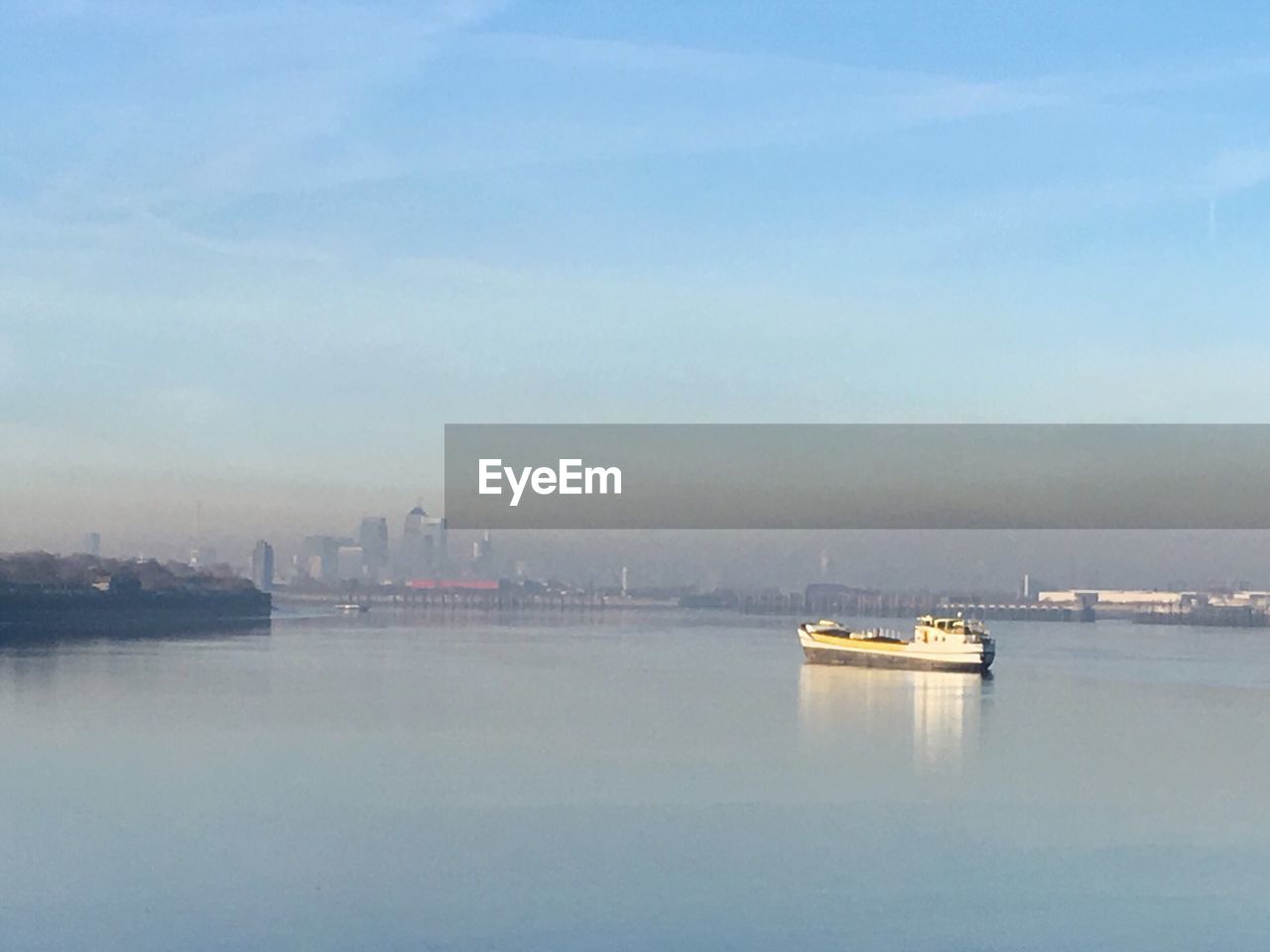 SHIP IN WATER AGAINST SKY IN CITY