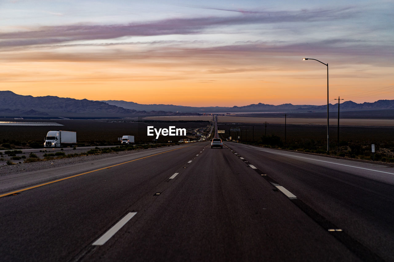 ROAD AGAINST SKY AT SUNSET