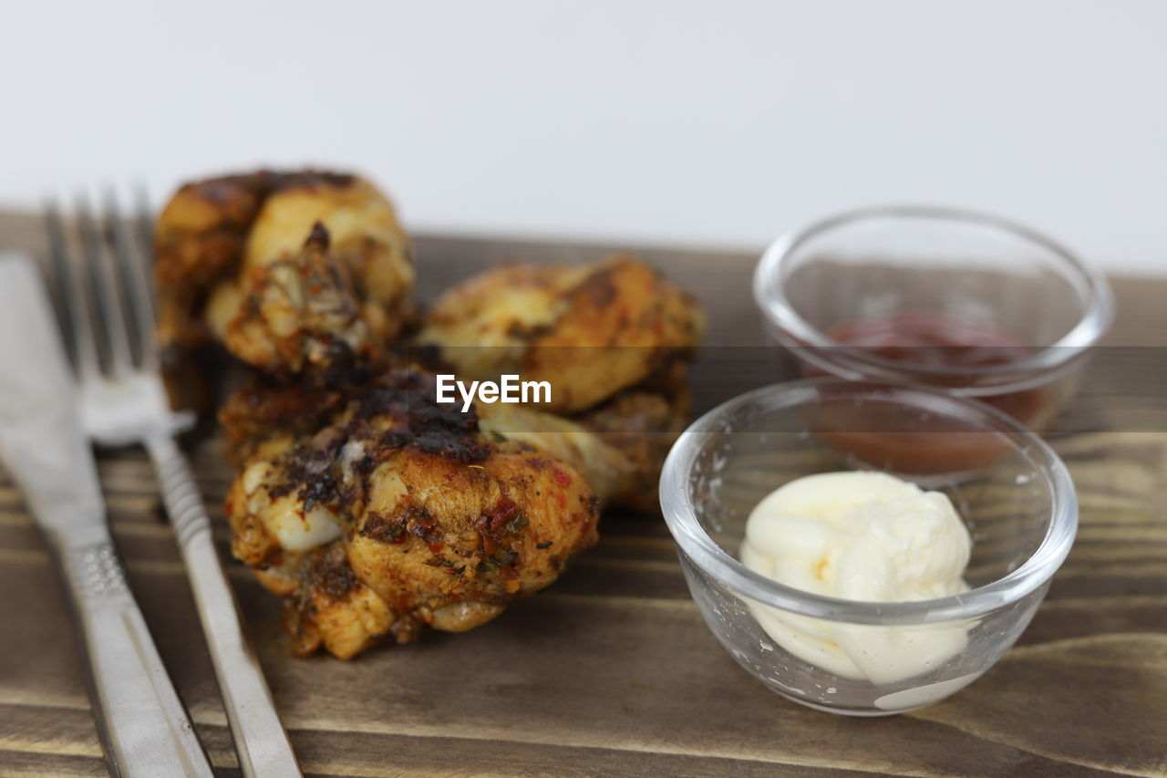 food and drink, food, dish, freshness, produce, breakfast, healthy eating, meal, dessert, indoors, no people, wellbeing, fried food, studio shot, meat, wood, close-up, baked, eating utensil, cuisine, focus on foreground, kitchen utensil, vegetable, household equipment, chicken meat, table