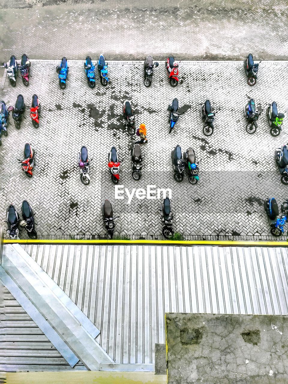 Student is walking through the motorcycle parking lot