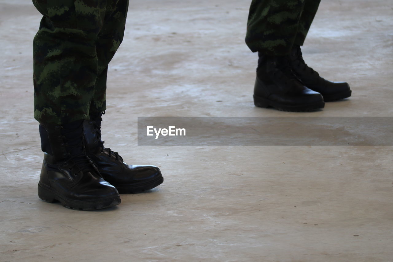 low section of soldiers standing on floor