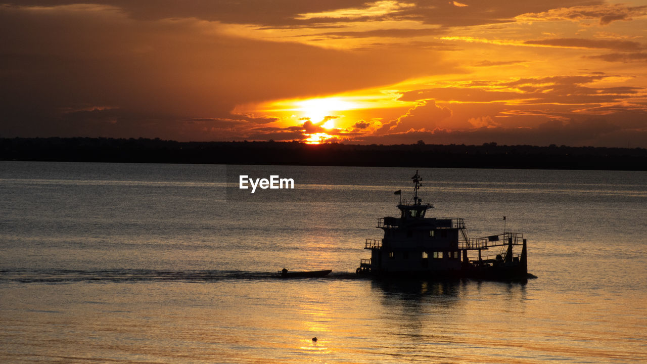 Sunset with a boat in amazon river