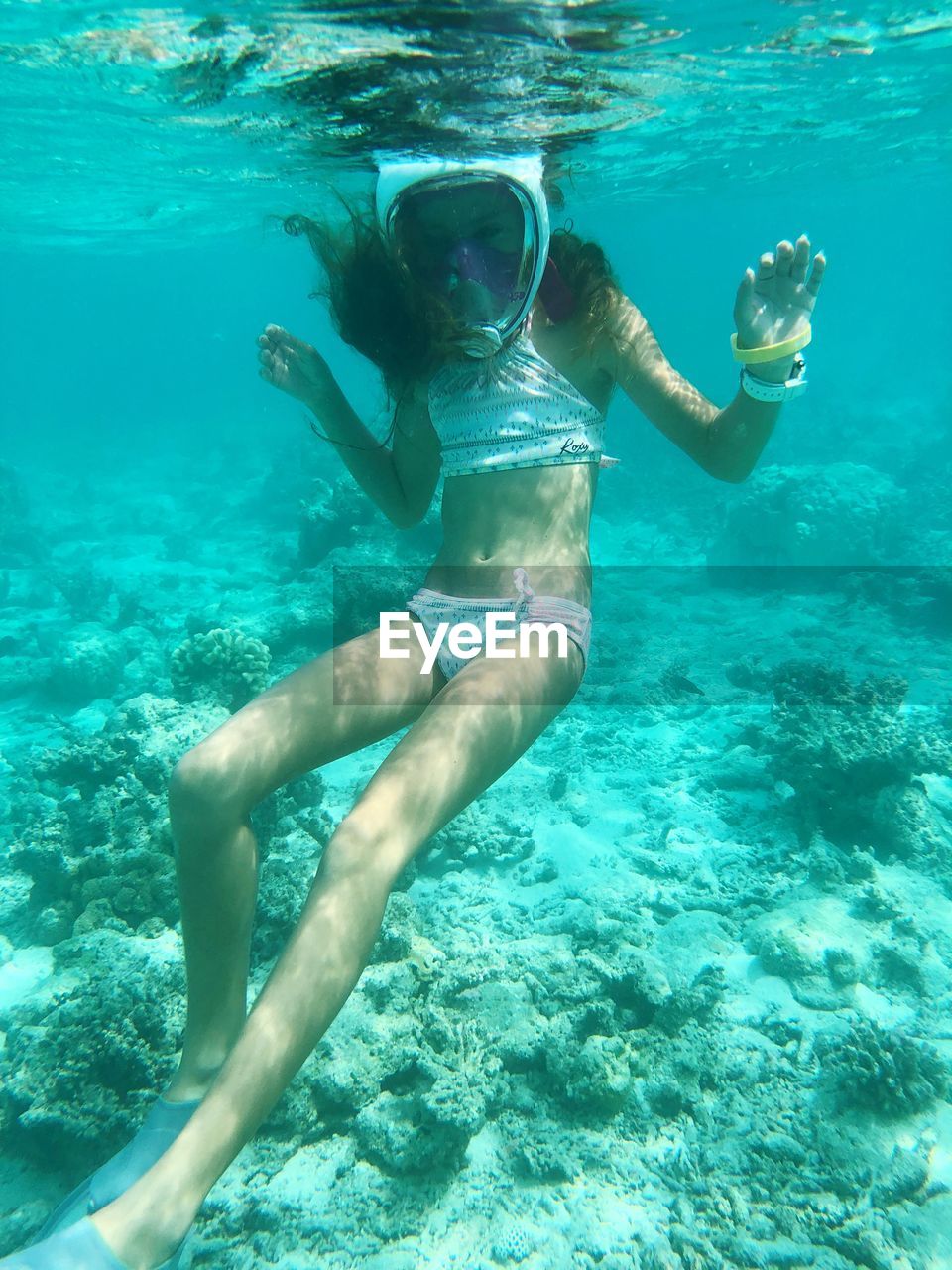 REFLECTION OF WOMAN IN SEA