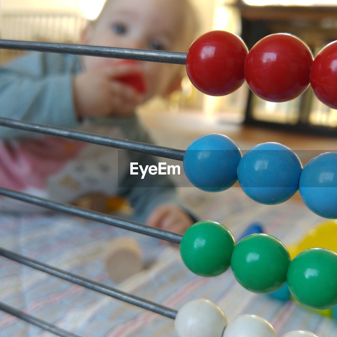 Close-up of abacus against baby at home