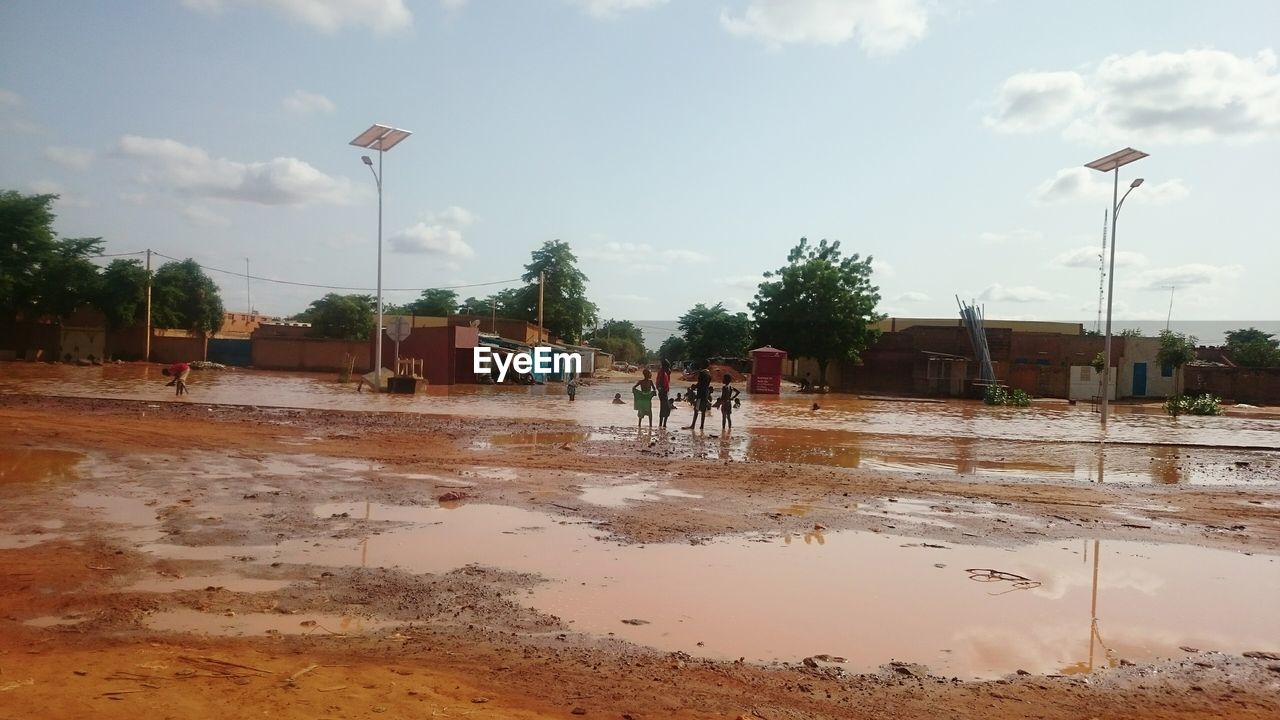 REFLECTION OF PEOPLE IN PUDDLE