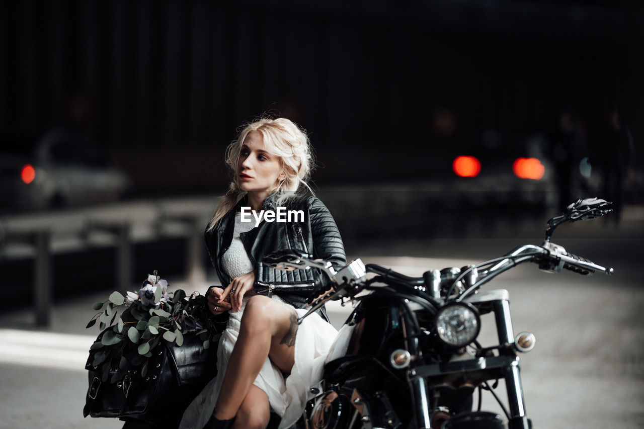 Portrait of woman riding motorcycle in city