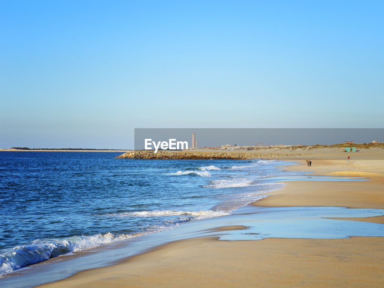 Scenic view of beach against clear sky