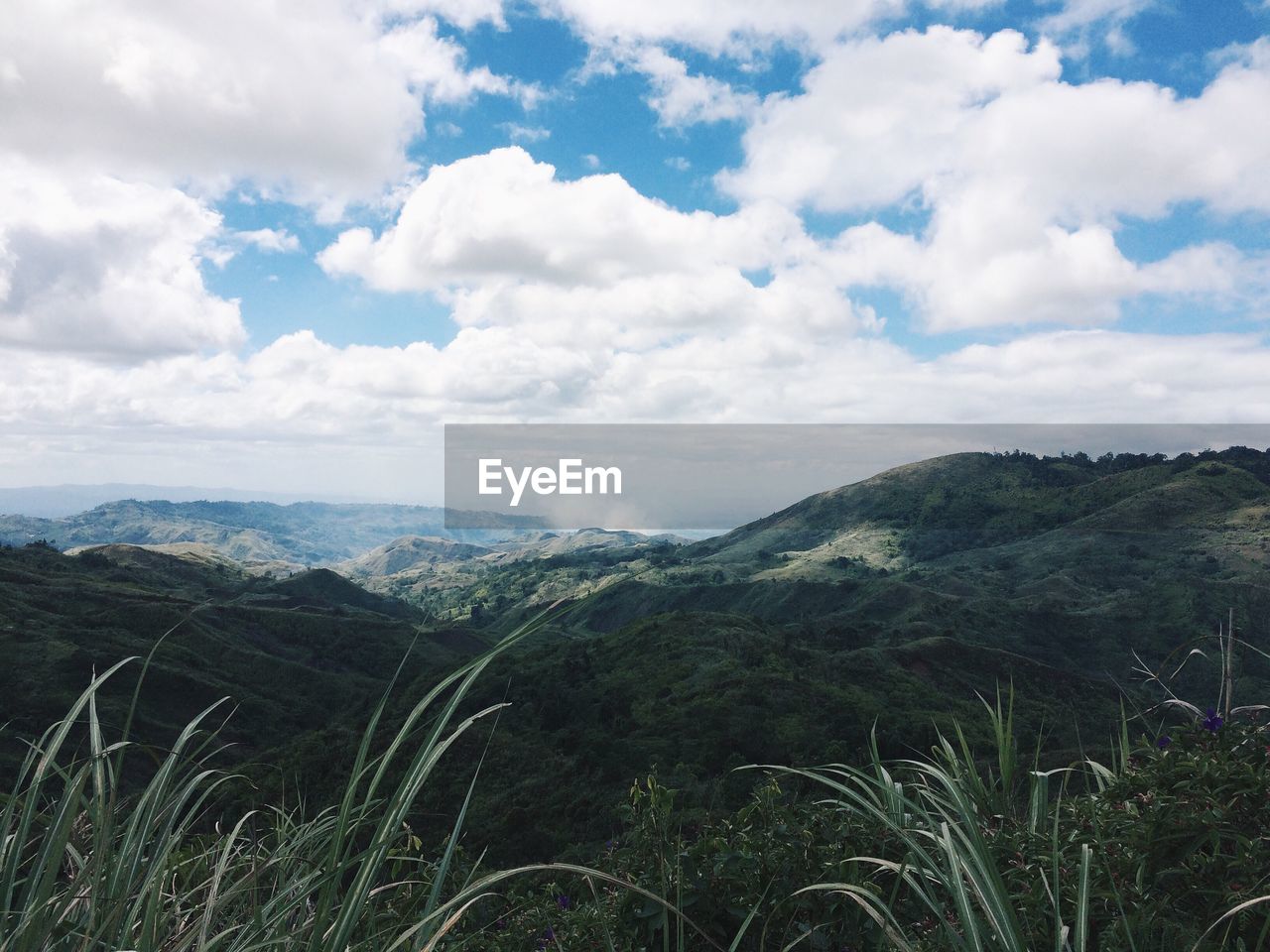 Scenic view of landscape against cloudy sky