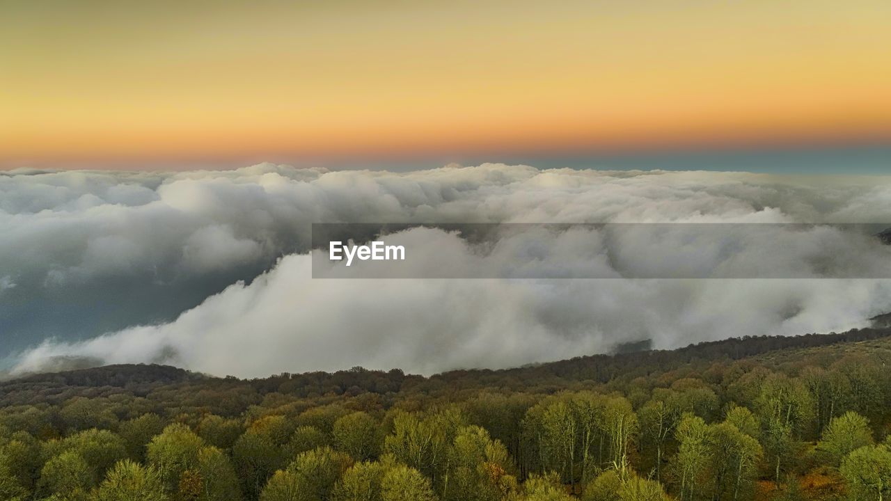 SCENIC VIEW OF LANDSCAPE AGAINST ORANGE SKY