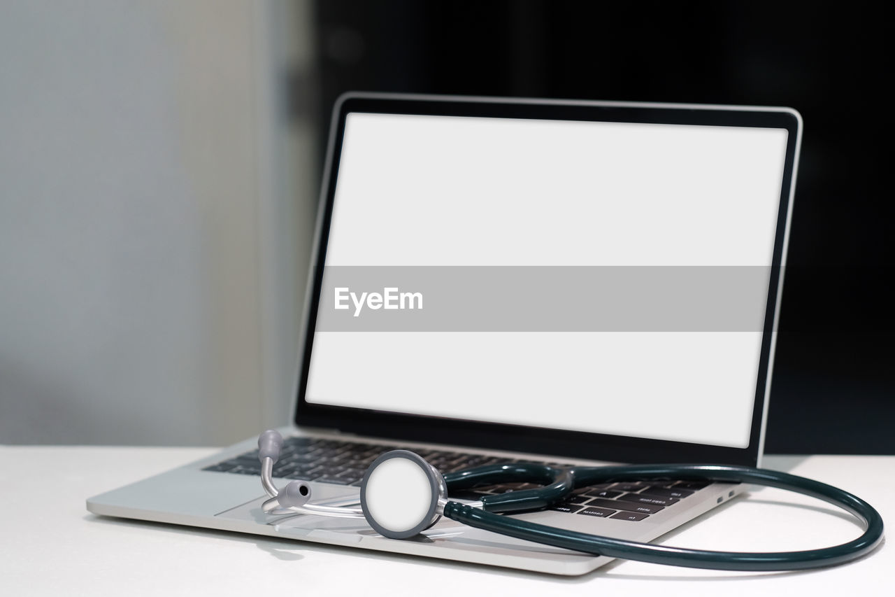 White screen laptop computer with stethoscope