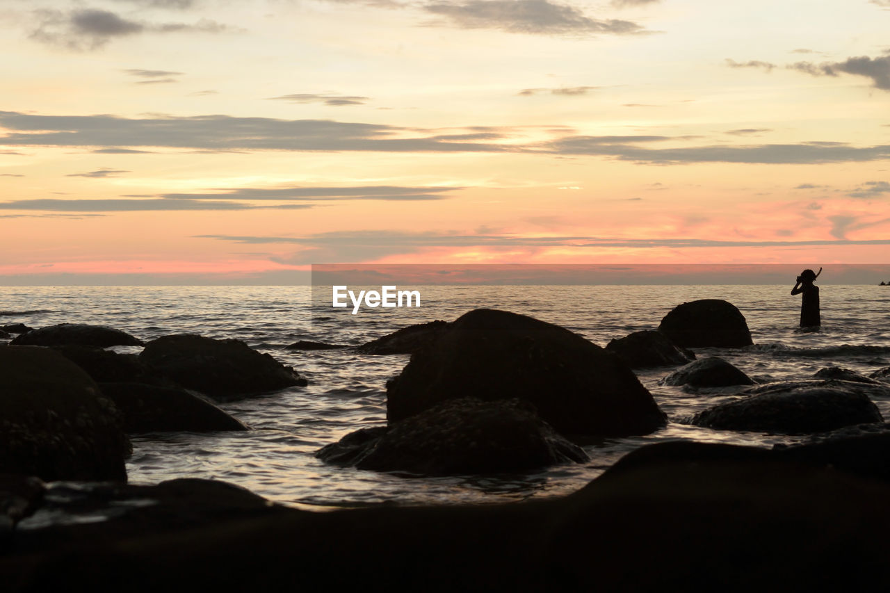 Silhouette of rocks on beach