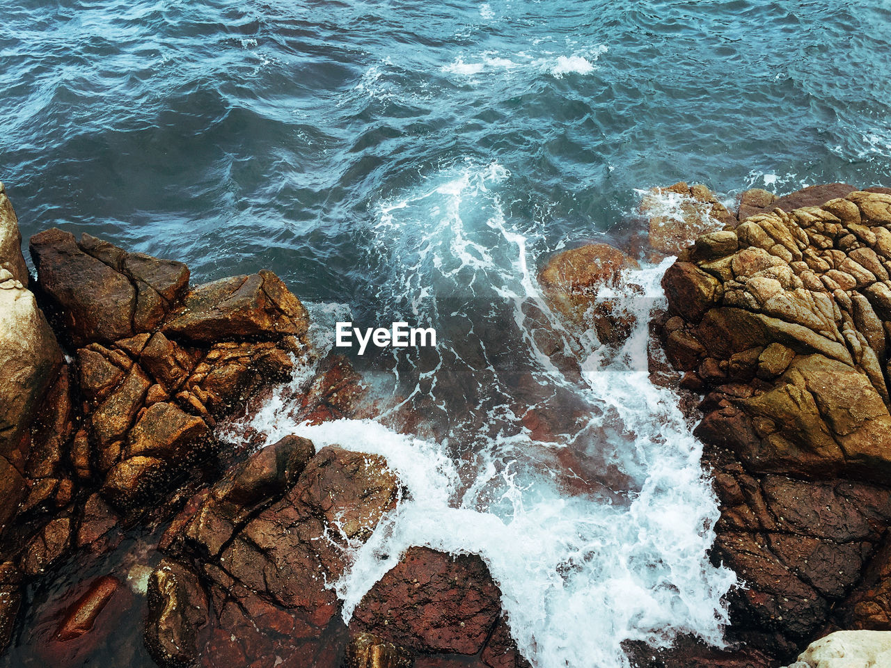 High angle view of rocks in sea