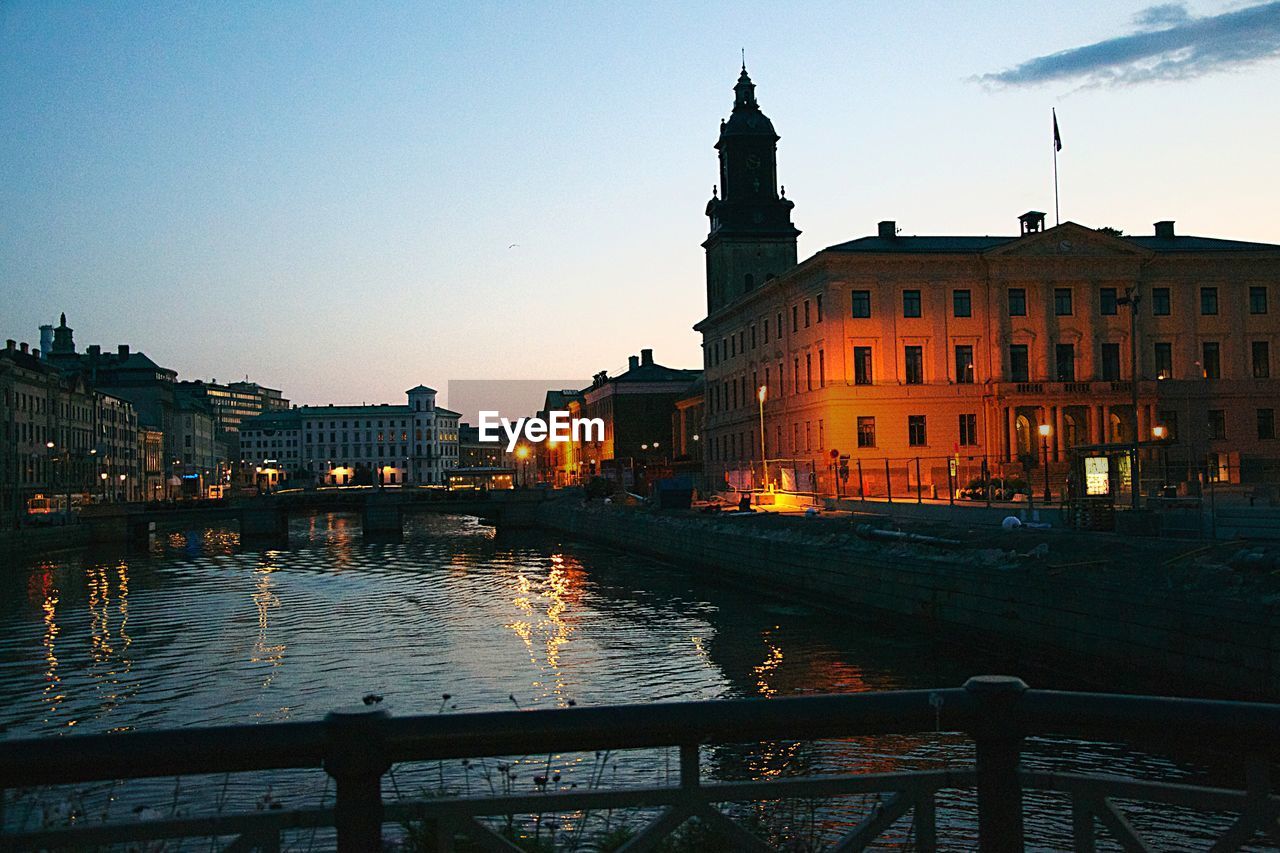 River along buildings and against clear sky