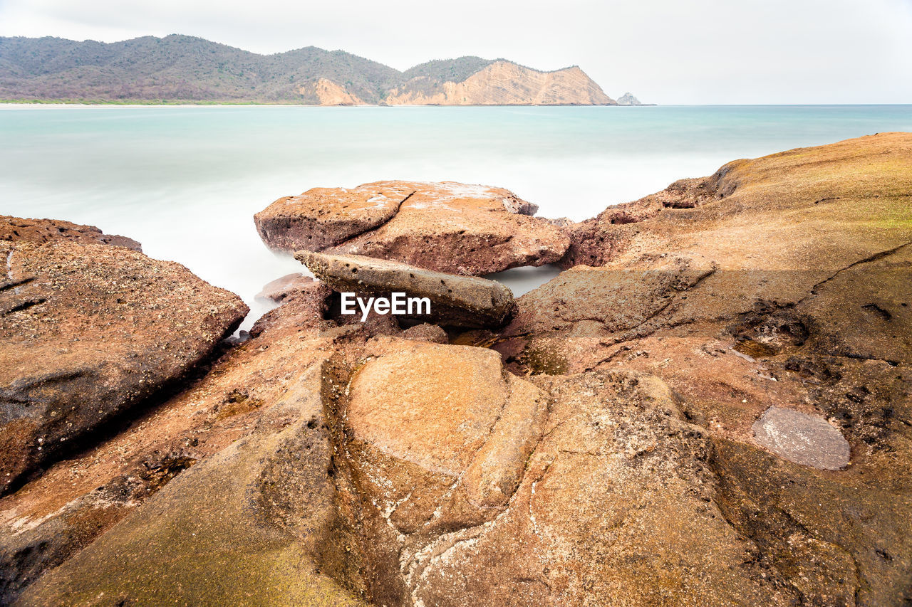 Panoramic view of rocks on beach against sky