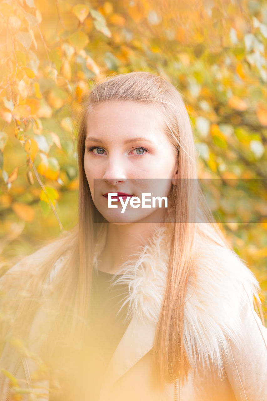 Portrait of girl against trees during autumn