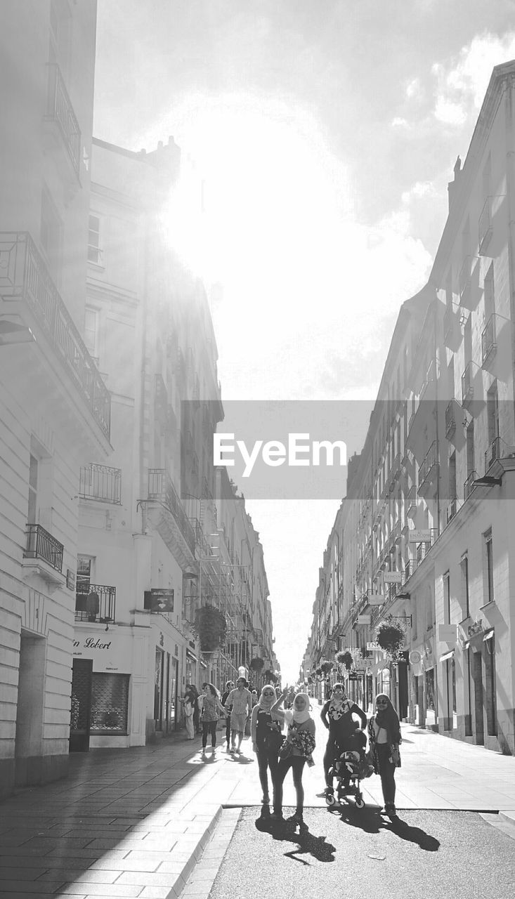 PEOPLE WALKING ON STREET IN CITY