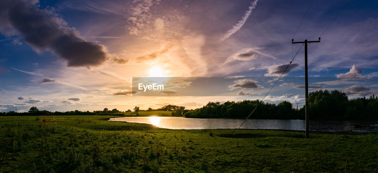 Scenic view of field against sky during sunset