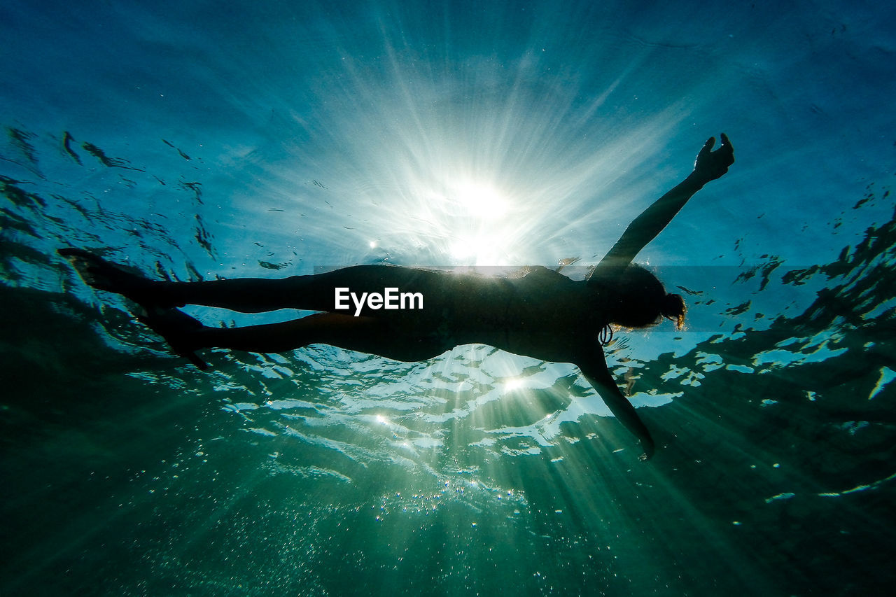 Low angle view of woman swimming in sea