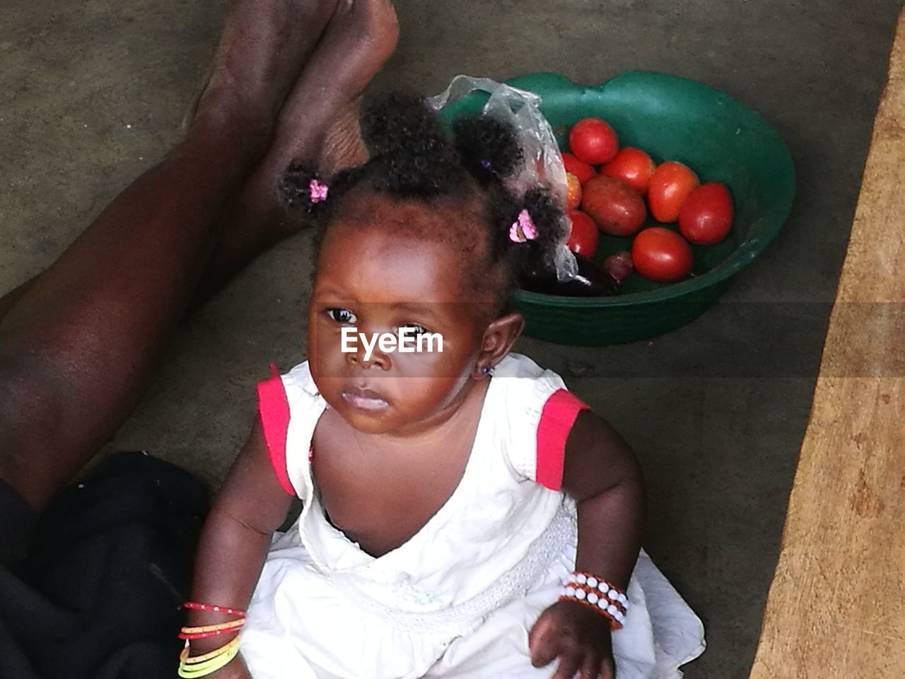 HIGH ANGLE PORTRAIT OF GIRL WITH TOMATOES IN CONTAINER