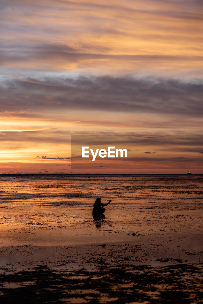 sky, sunset, water, sea, beauty in nature, silhouette, beach, nature, land, cloud, ocean, orange color, scenics - nature, one person, horizon, shore, coast, horizon over water, wave, tranquility, leisure activity, lifestyles, body of water, men, tranquil scene, motion, outdoors, animal, full length, dawn, sports, idyllic, animal themes, holiday, evening, reflection, vacation, one animal