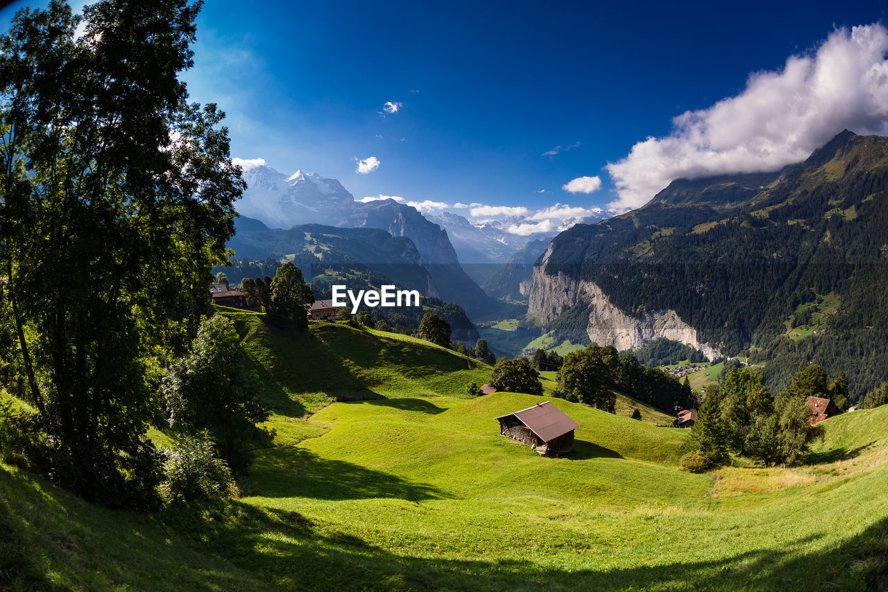 Scenic view of mountains against blue sky