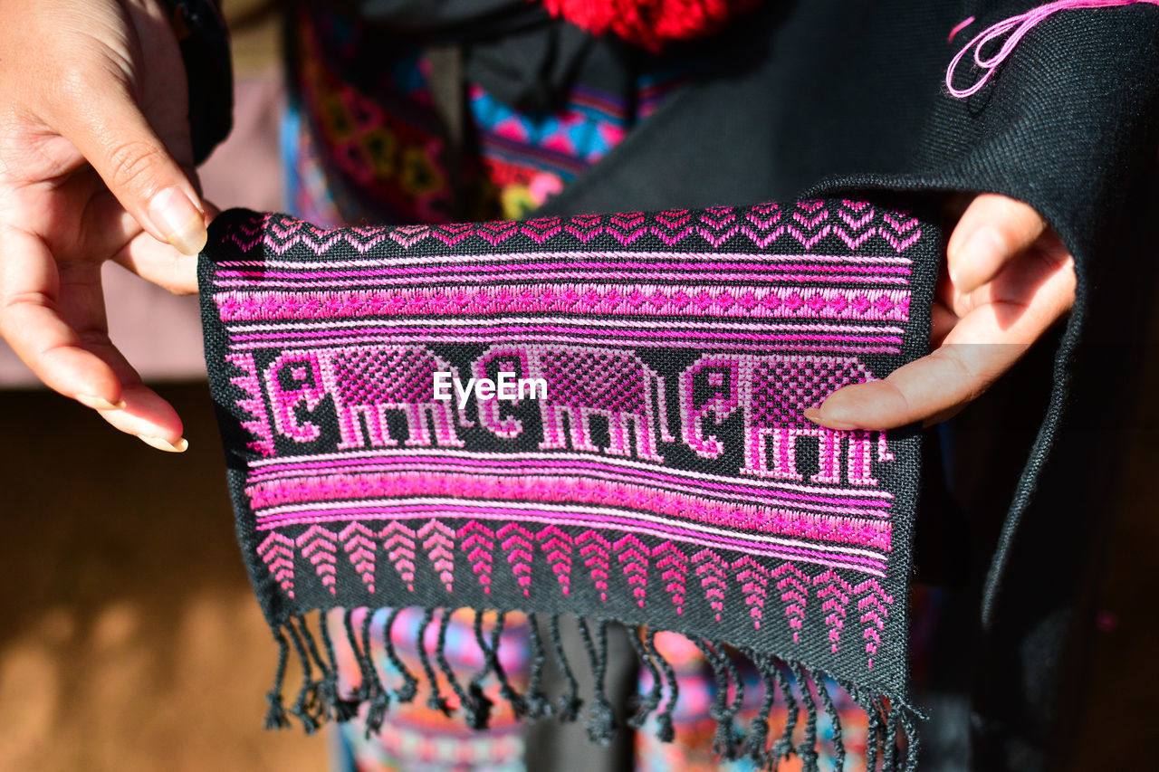 Midsection of woman holding embroidery fabric