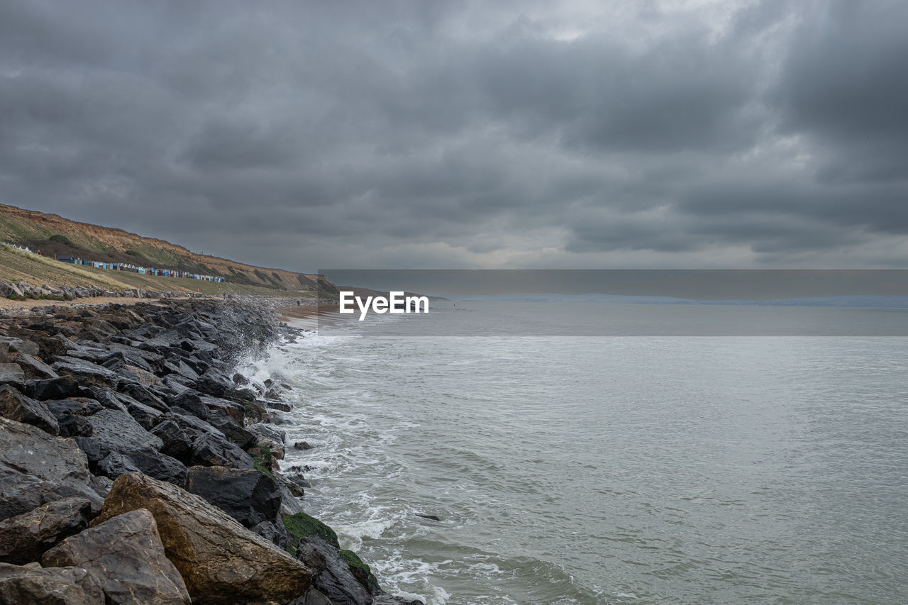 cloud, water, sea, sky, coast, shore, scenics - nature, ocean, beauty in nature, land, environment, beach, body of water, rock, nature, overcast, landscape, dramatic sky, wave, storm, storm cloud, cliff, horizon, coastline, travel destinations, bay, seascape, tranquility, travel, no people, cloudscape, tranquil scene, outdoors, terrain, mountain, non-urban scene, tourism, atmospheric mood, horizon over water, day, moody sky, water's edge, motion, idyllic, wind wave