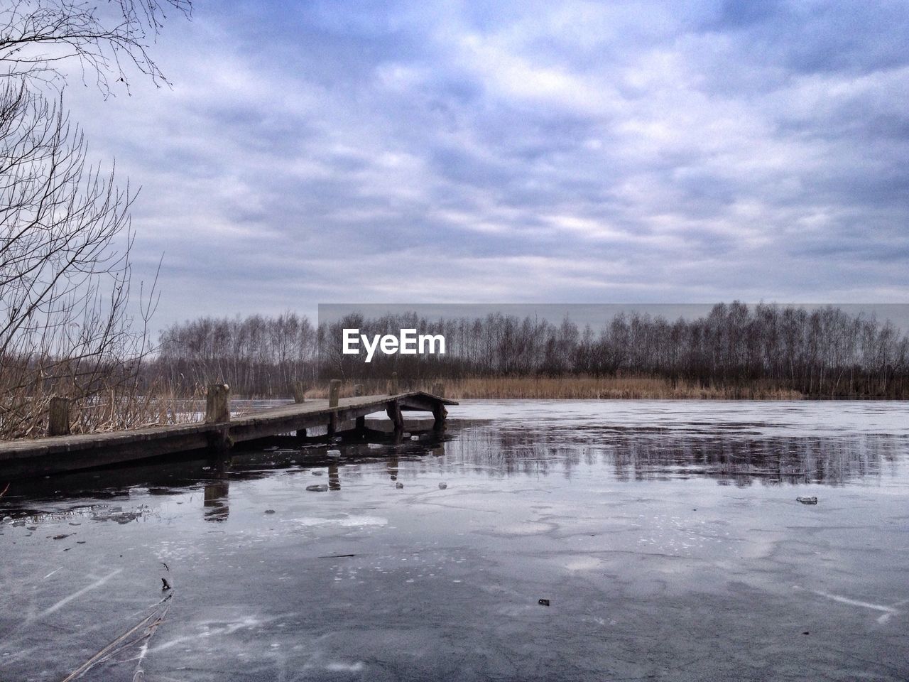 Scenic view of frozen lake against cloudy sky