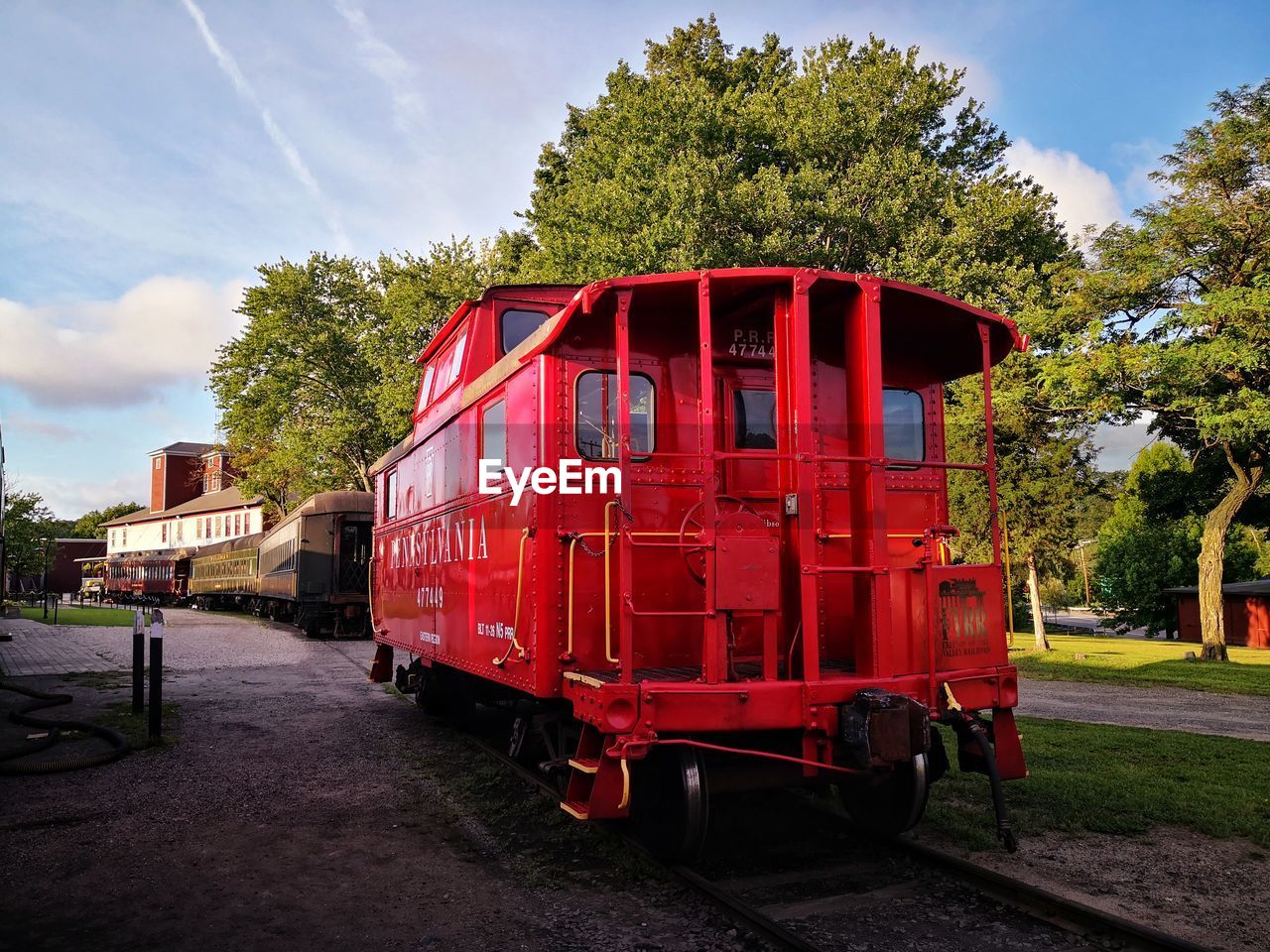 RED TRAIN ON RAILROAD TRACK