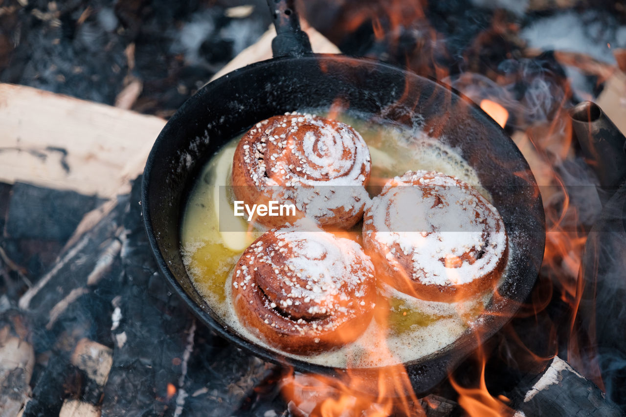 High angle view of cinnamon rolls in a pan on grill