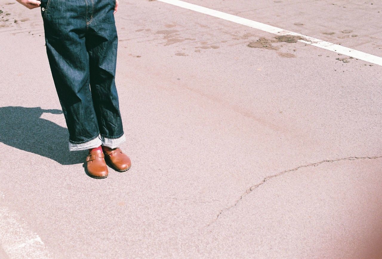 Low section of man standing on street