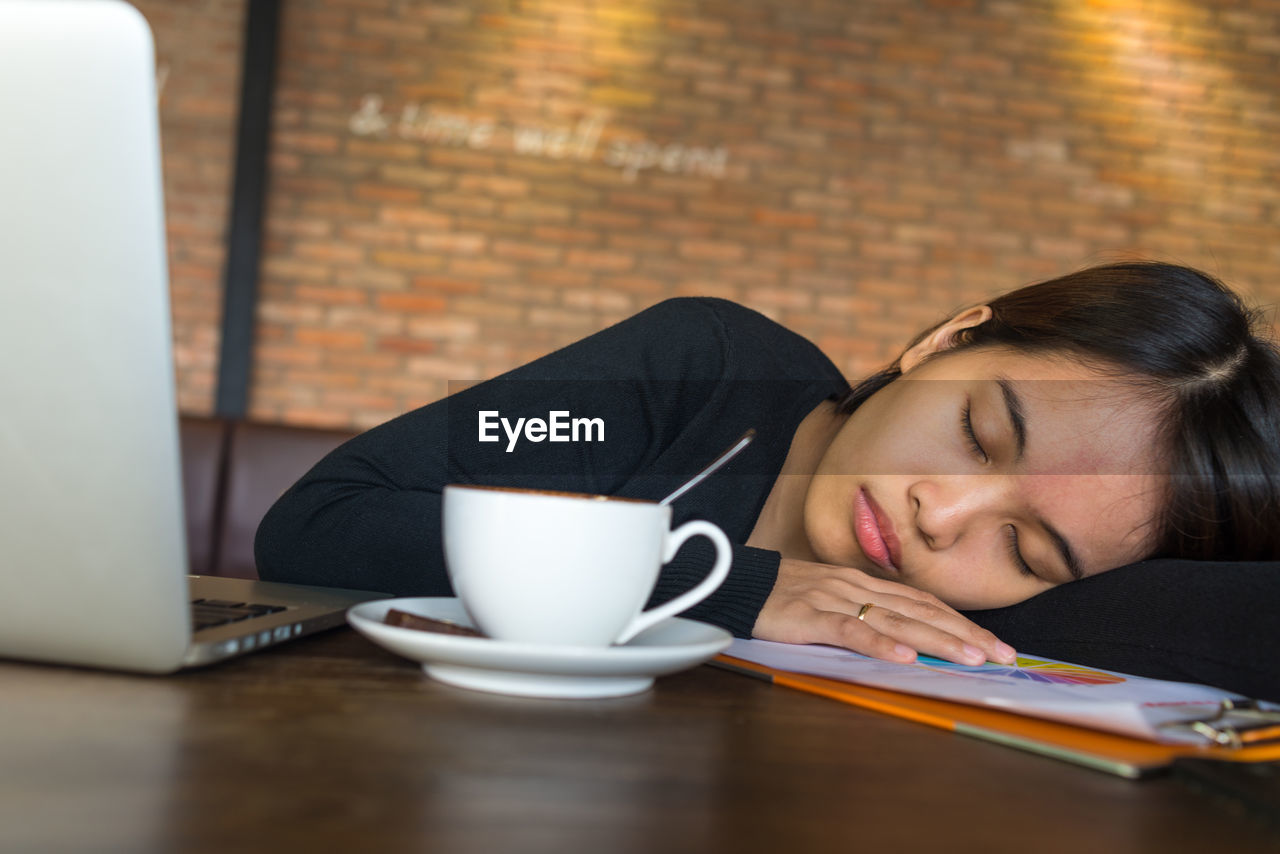 Young woman using laptop on table