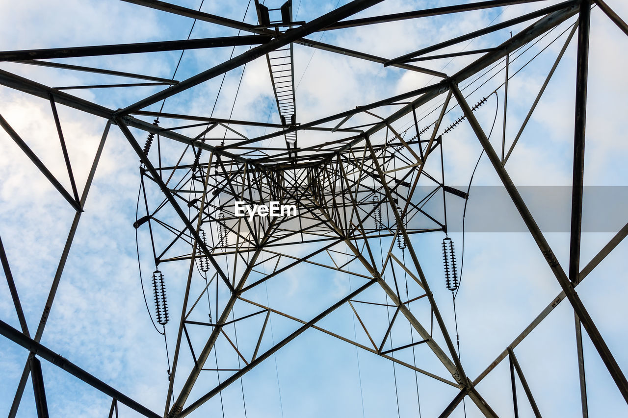 Low angle view of electricity pylon against sky