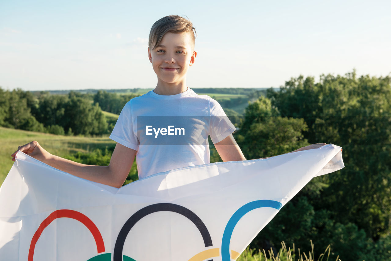 Portrait of boy holding flag