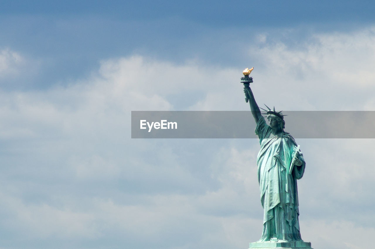 Statue of liberty against cloudy sky