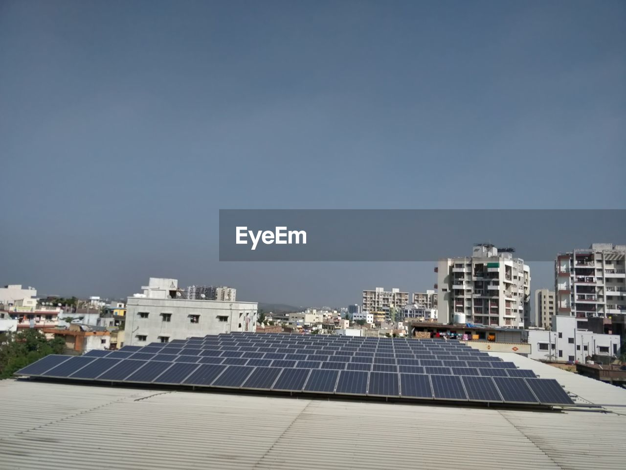 Scenic view of solar panels on buildings against clear sky