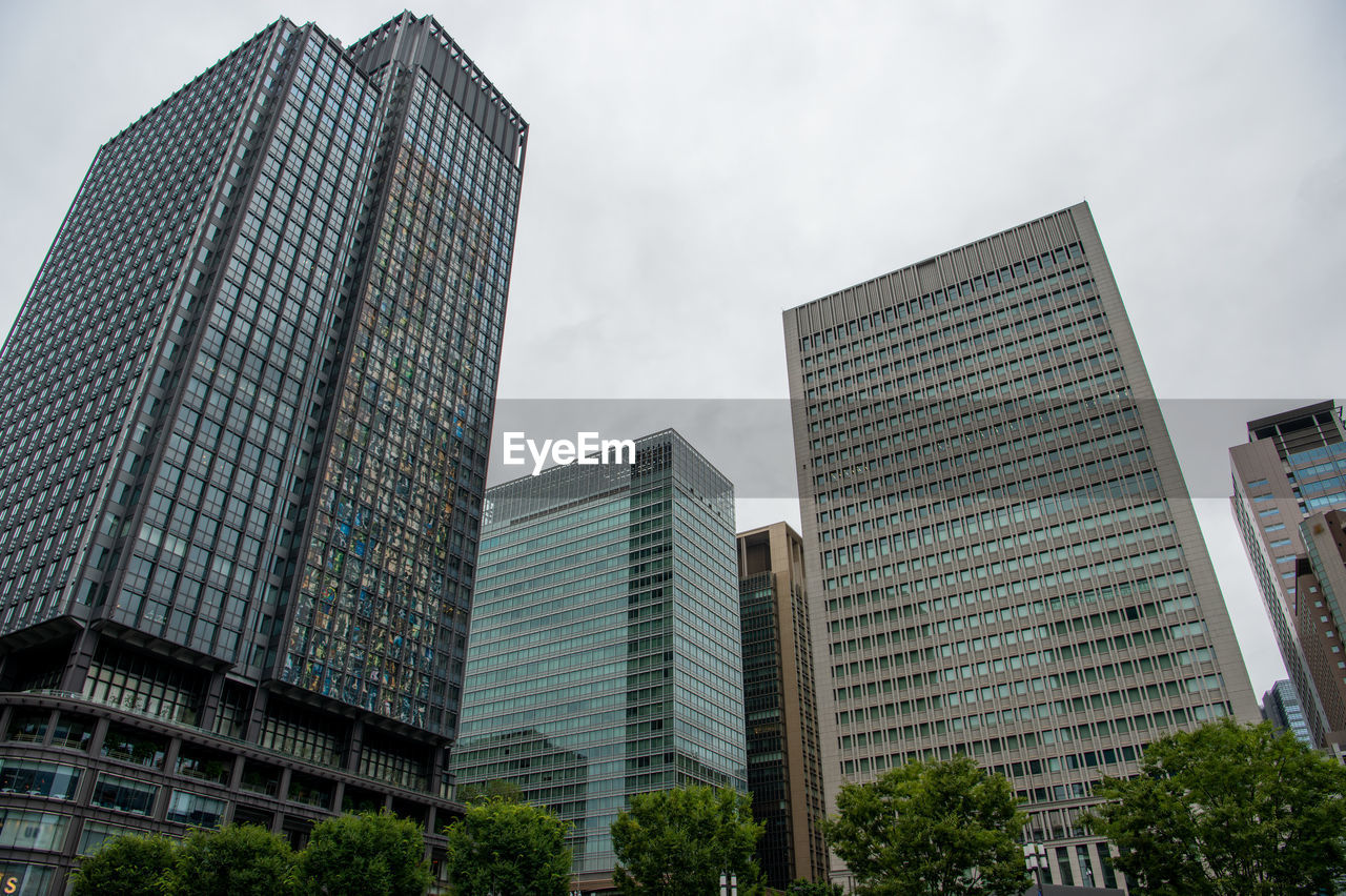 Low angle view of modern buildings against sky in city