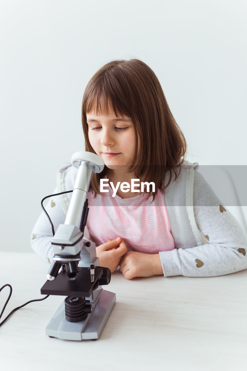 Portrait of girl looking down on table