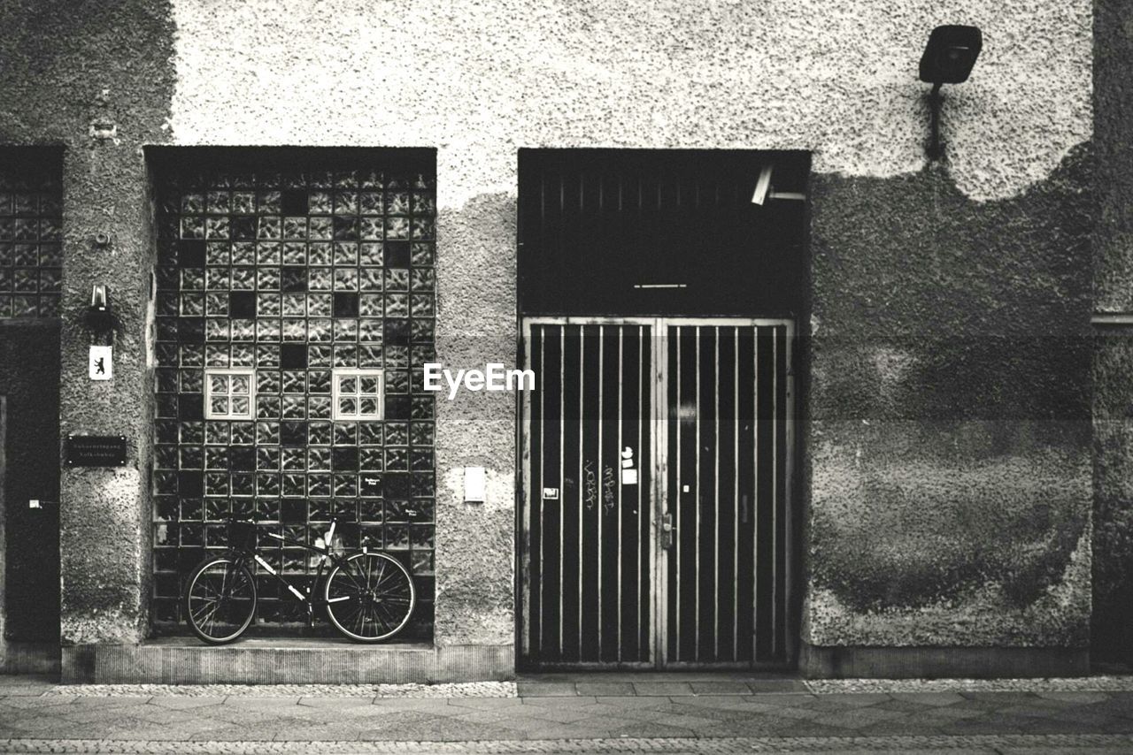 Street with bicycle and gate in facade