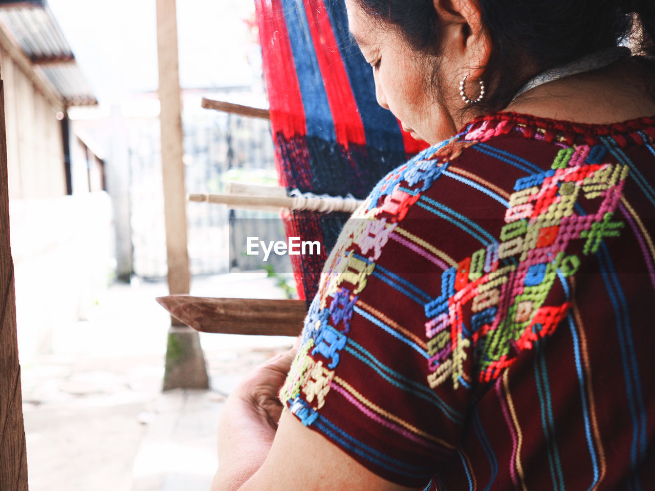 MIDSECTION OF WOMAN WEARING MULTI COLORED UMBRELLA