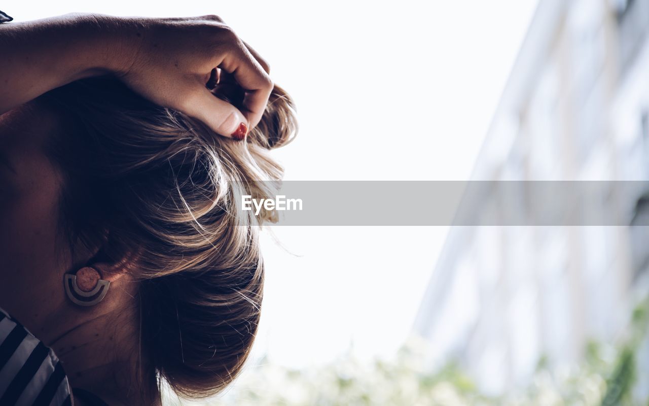 PORTRAIT OF BEAUTIFUL WOMAN AGAINST SKY WITH PALM TREES