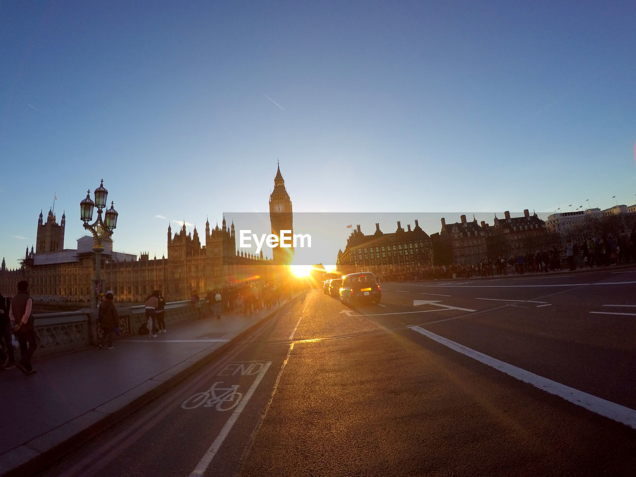 VIEW OF CITY STREET AGAINST SUNSET SKY