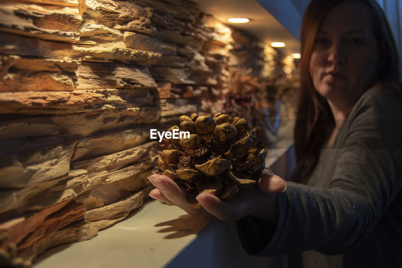 Woman holding pine cone