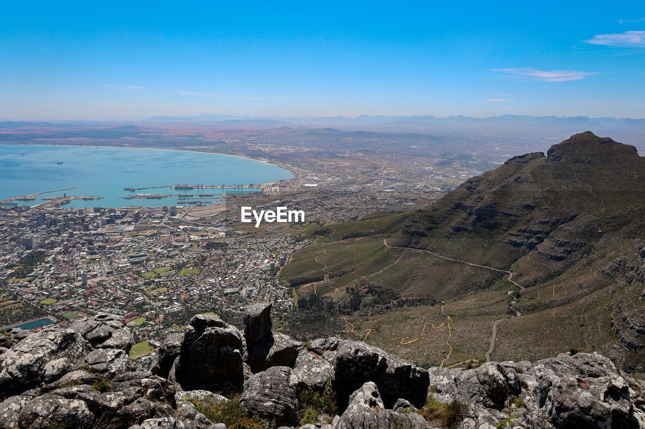 landscape, environment, scenics - nature, nature, sky, mountain, land, beauty in nature, travel destinations, water, adventure, wilderness, travel, walking, rock, geology, mountain range, sea, no people, tranquility, ridge, outdoors, tourism, blue, tranquil scene, non-urban scene, day, plateau, cloud, high angle view, architecture, beach, volcano, aerial photography