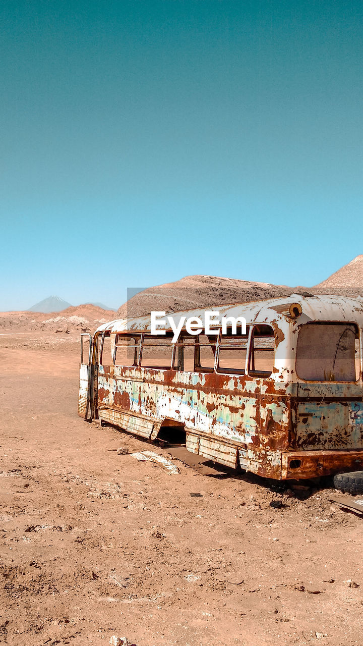 Abandoned truck against clear blue sky