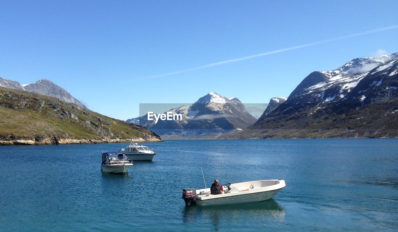 Scenic view of mountains against clear blue sky