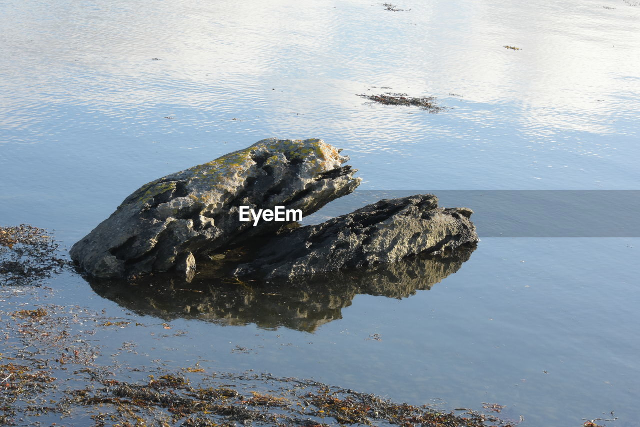 REFLECTION OF ROCKS IN SEA