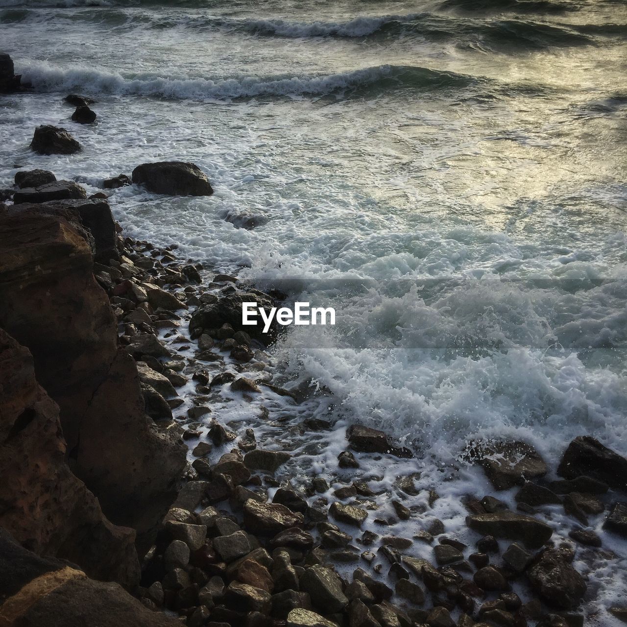 Waves splashing on rocks at beach